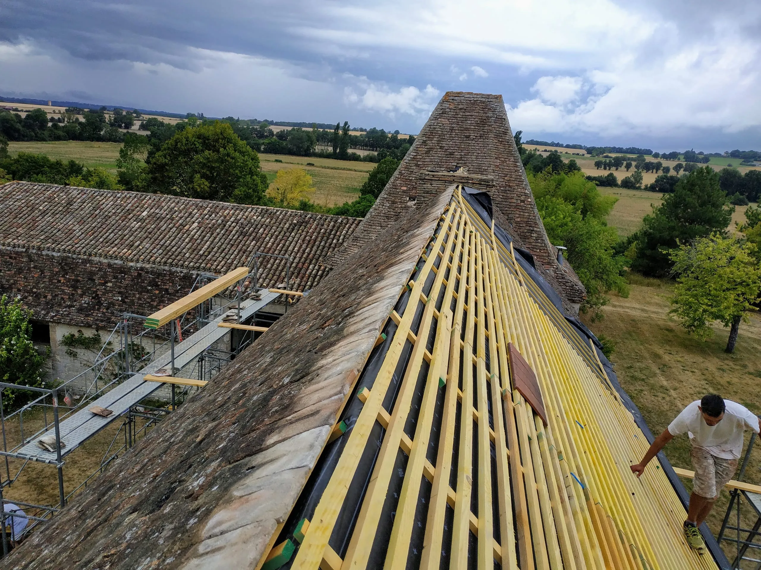 Toiture ancienne en rénovation avec écran sous-toiture et liteaux neufs sur un versant