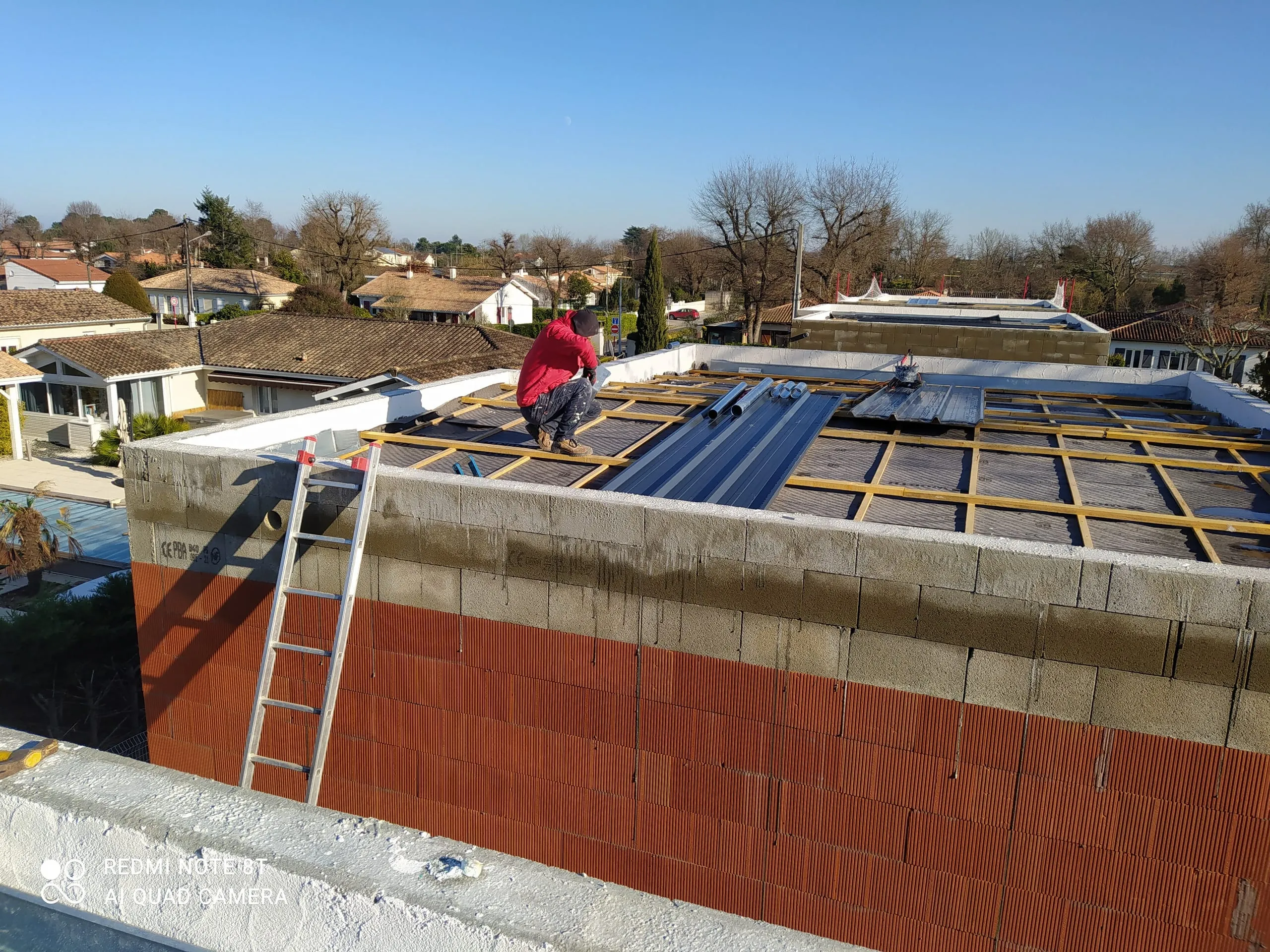 Couvreur travaillant sur les liteaux d’une toiture-terrasse en préparation